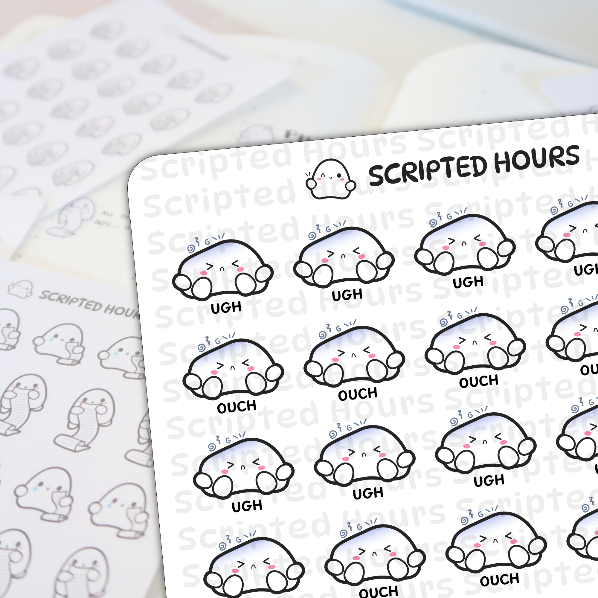 Scripted Hours brand sticker sheets displaying white ghost-like characters with pink cheeks and blue gradient tops, some expressing "UGH" and "OUCH", on a light desk surface with a winking ghost logo and blurred background sticker sheets