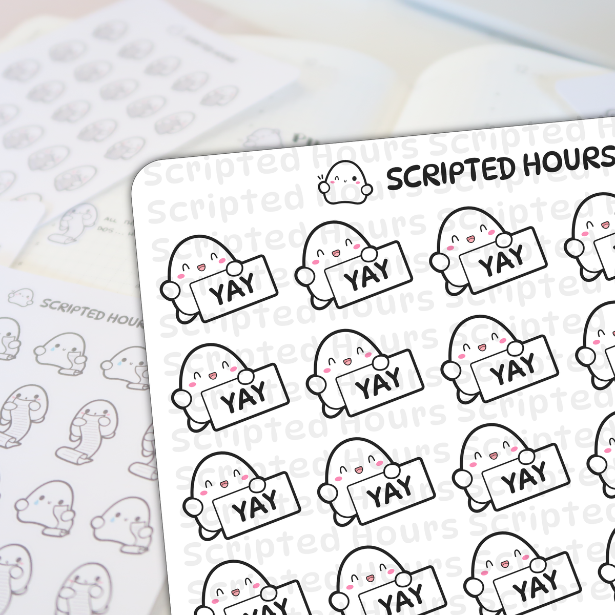 Scripted Hours sticker sheets displaying rows of cheerful white characters with pink cheeks holding 'YAY' signs, alongside a blurred sheet of characters holding scrolls and crying, all beneath the brand's winking logo character