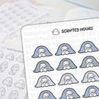 Digital illustration by Scripted Hours showcasing a sheet of cozy planner stickers featuring adorable white blob characters with rosy cheeks under light blue and grey blankets holding mugs of coffee, alongside a blurred sheet of grayscale outline stickers