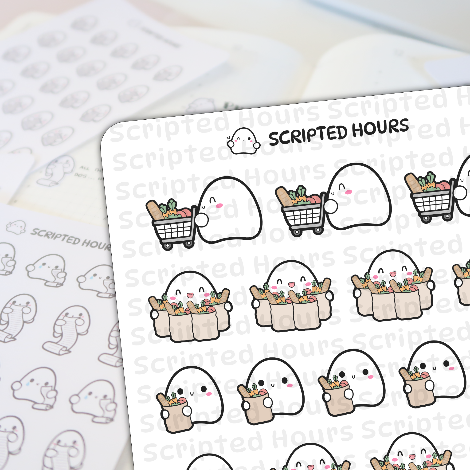 Scripted Hours vinyl stickers depicting cute ghost characters grocery shopping, either pushing carts or holding paper bags filled with baguettes and colorful produce, some with happy winking expressions and rosy cheeks, visible on a sticker sheet with other ghost planner icons in the background