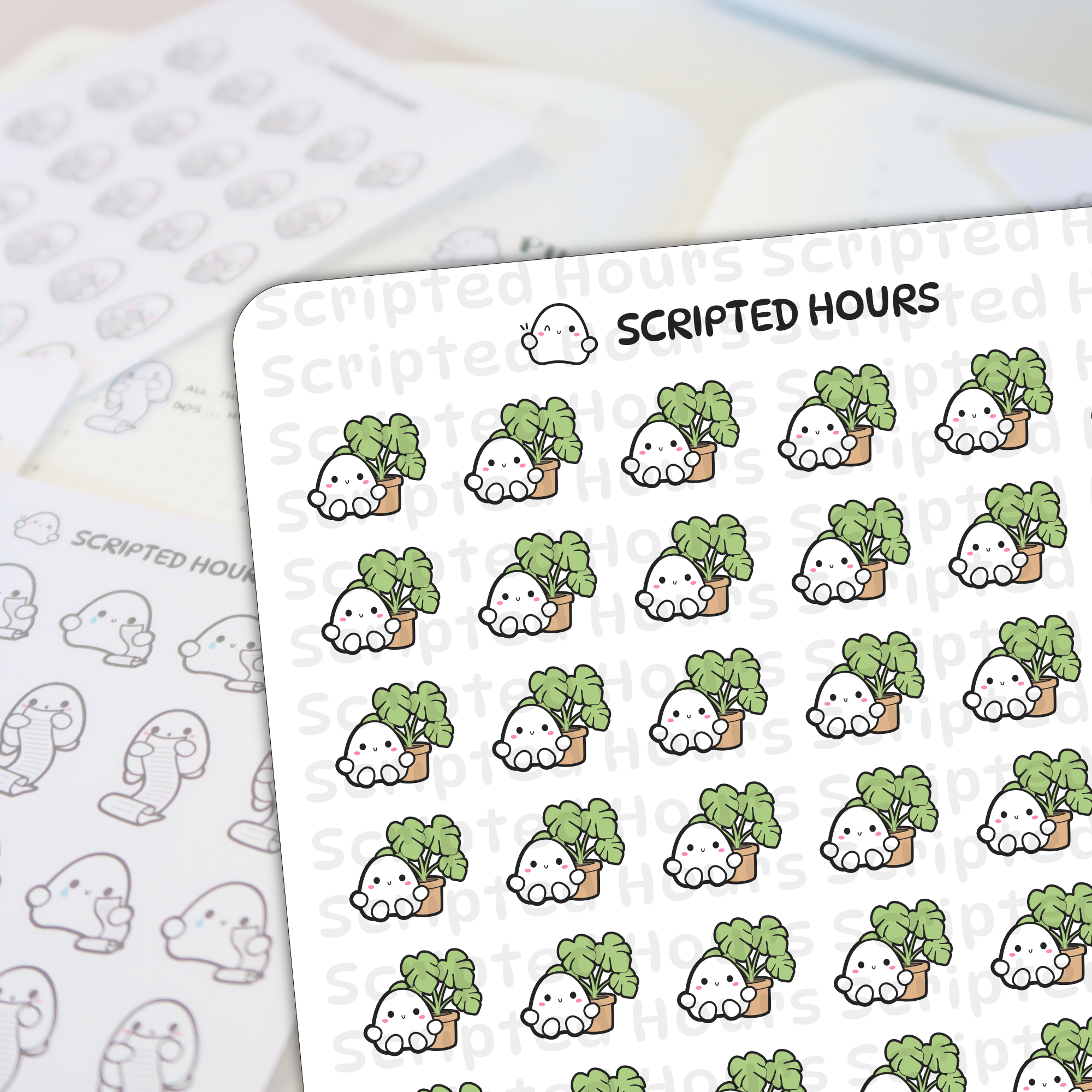 Scripted Hours die-cut sticker sheet displaying rows of cute white ghost characters with pink blush smiles peeking over vibrant green leafy plants in small brown pots, alongside a blurred background sheet of grayscale ghost doodles