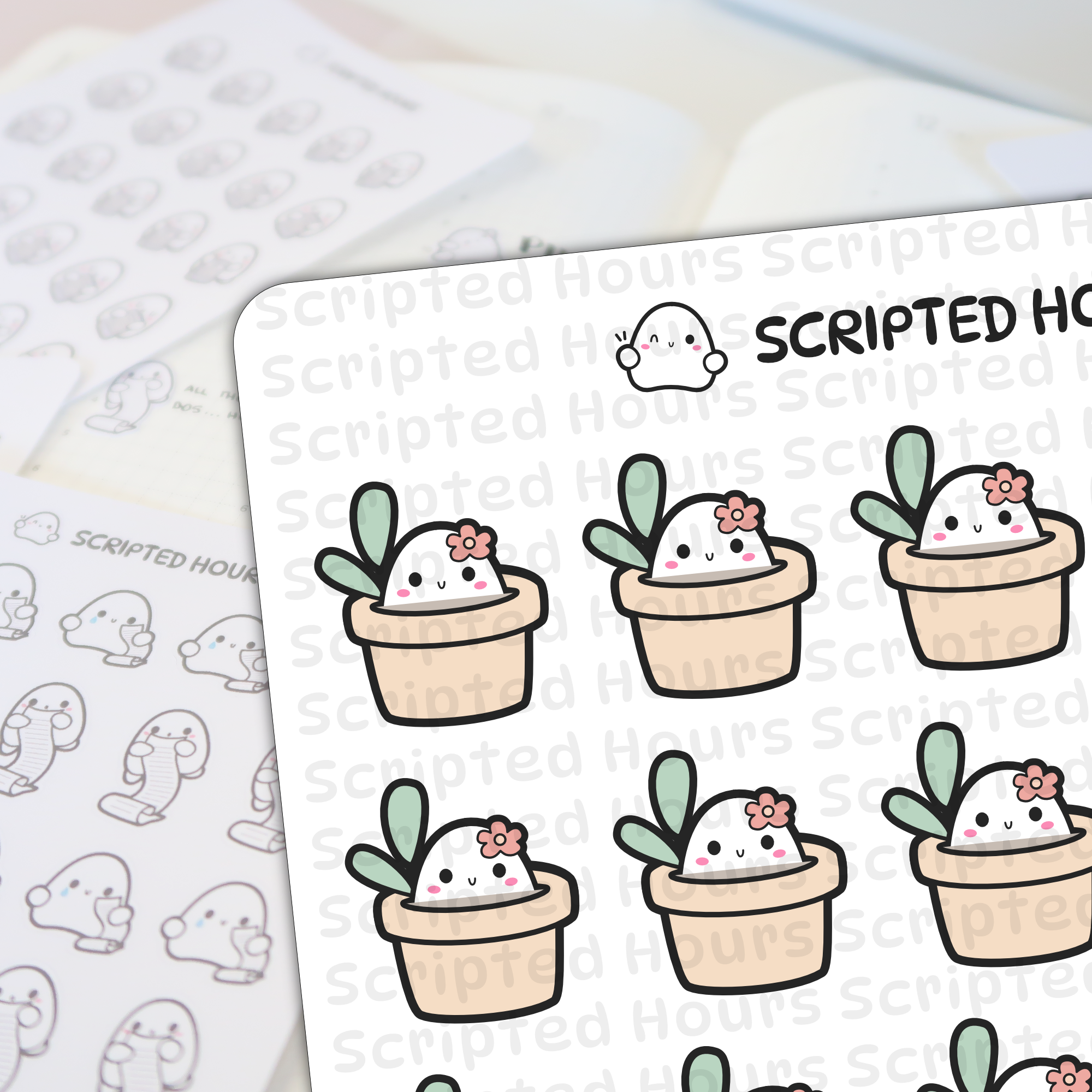 Digital illustration stickers by Scripted Hours depicting cheerful white succulent characters with pink blush and small pink flowers on their heads, nestled in pale beige pots with green leaves, on a desk with other blurred ghost-shaped planner stickers