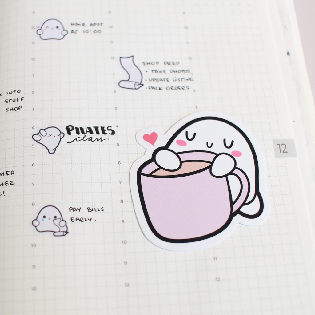 Illustrated ghost character with a cup of coffee in a notebook