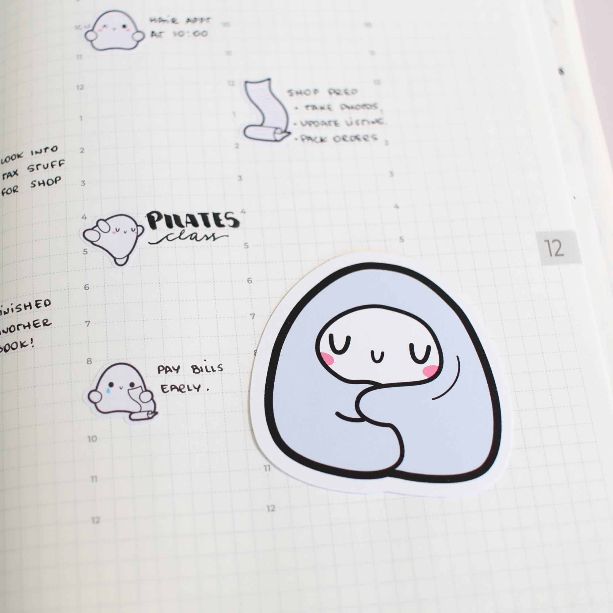 Sticker with a cute character design on a notebook page